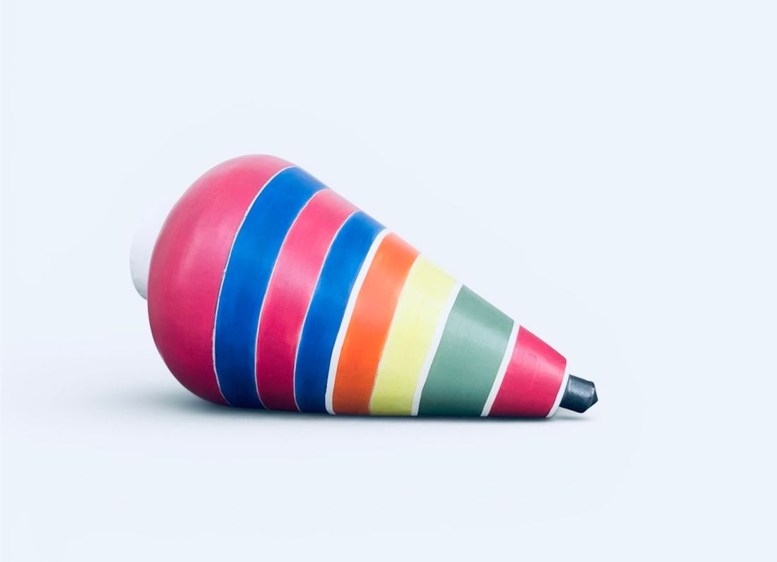 Trompo, a brightly striped ceramic sculpture by Ireri Krueger shaped like a spinning top